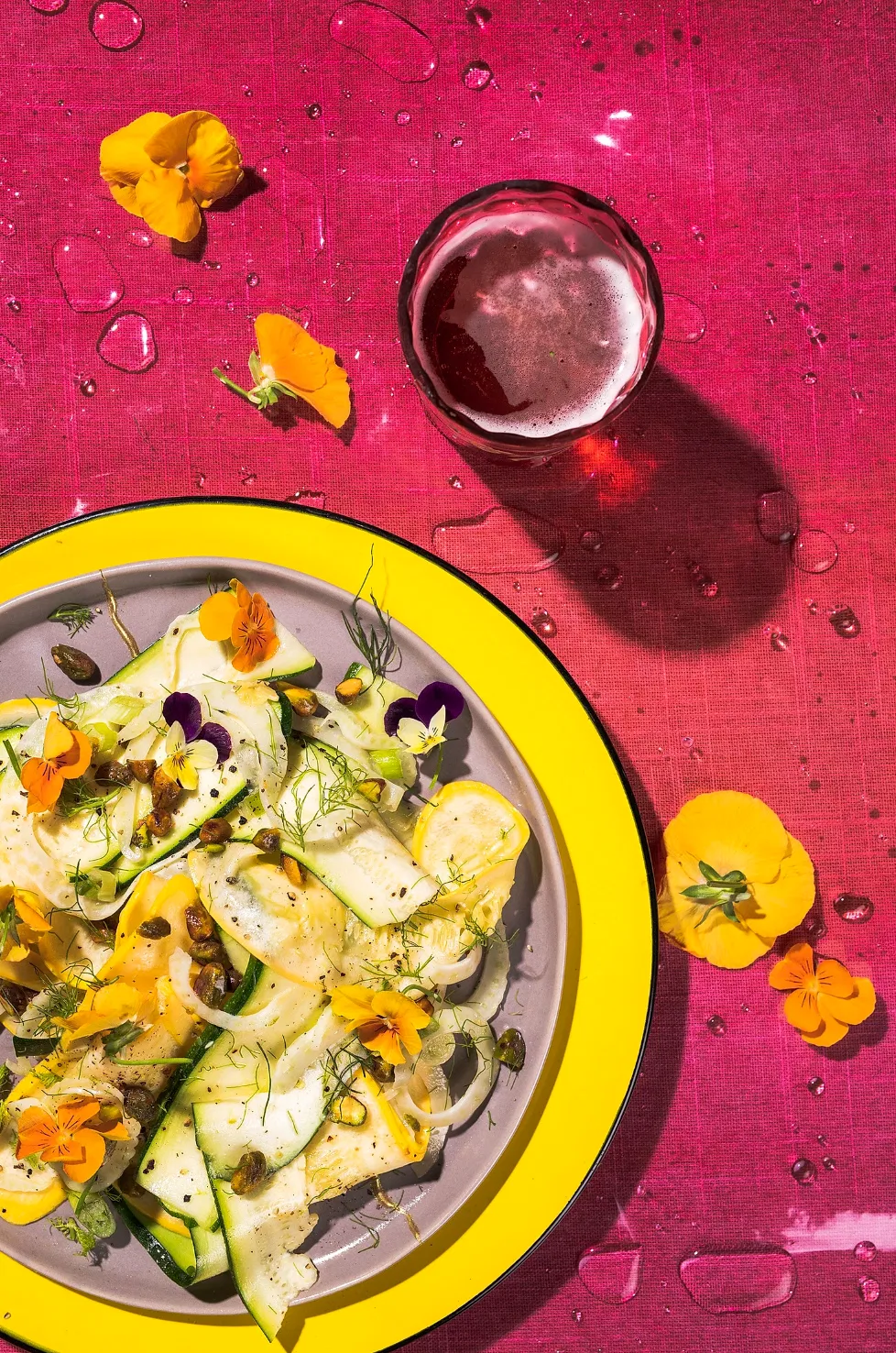 zucchini courgette salad with edible flowers on a vibrant colorful background