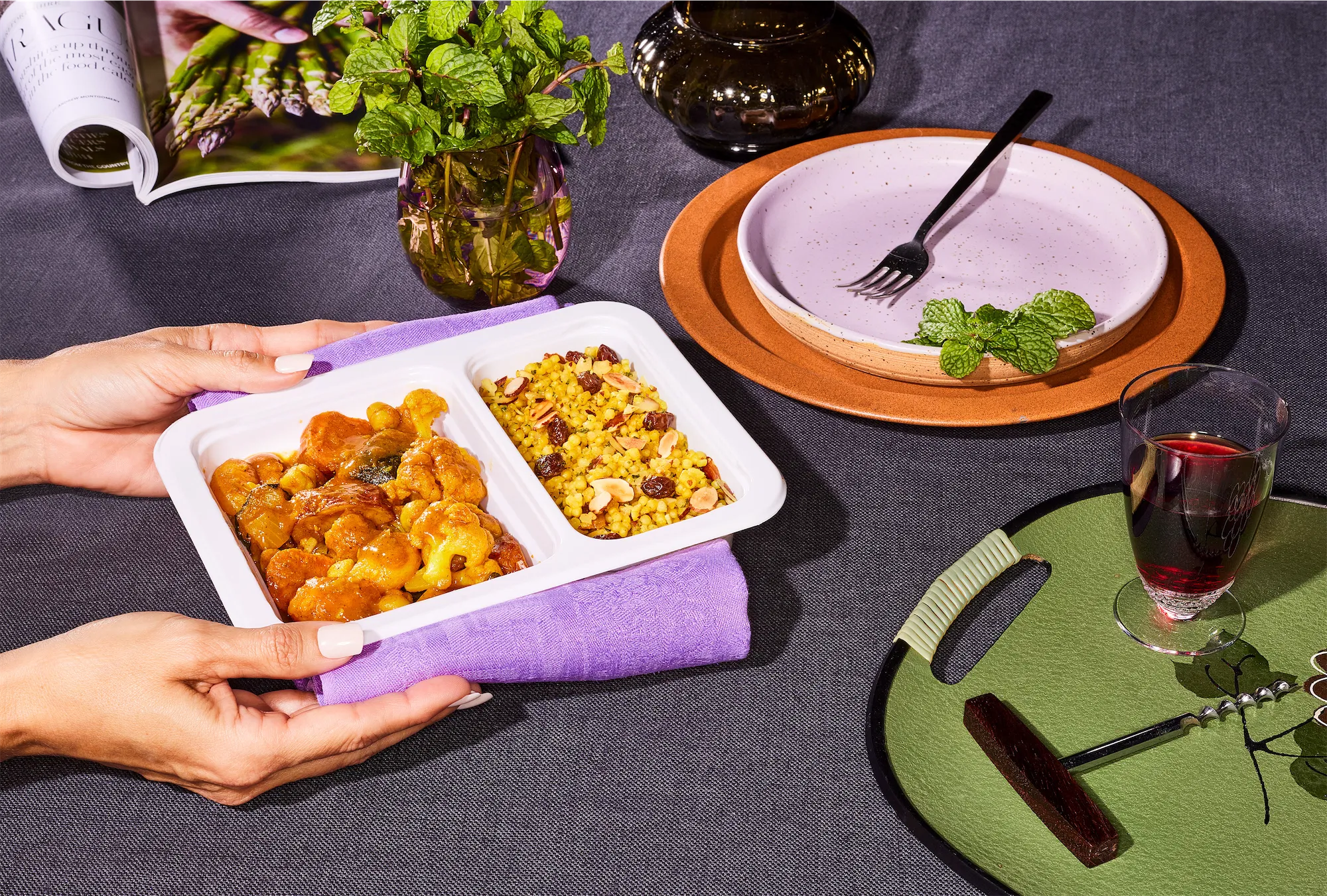  two hands holding ready meal with styalized home scene