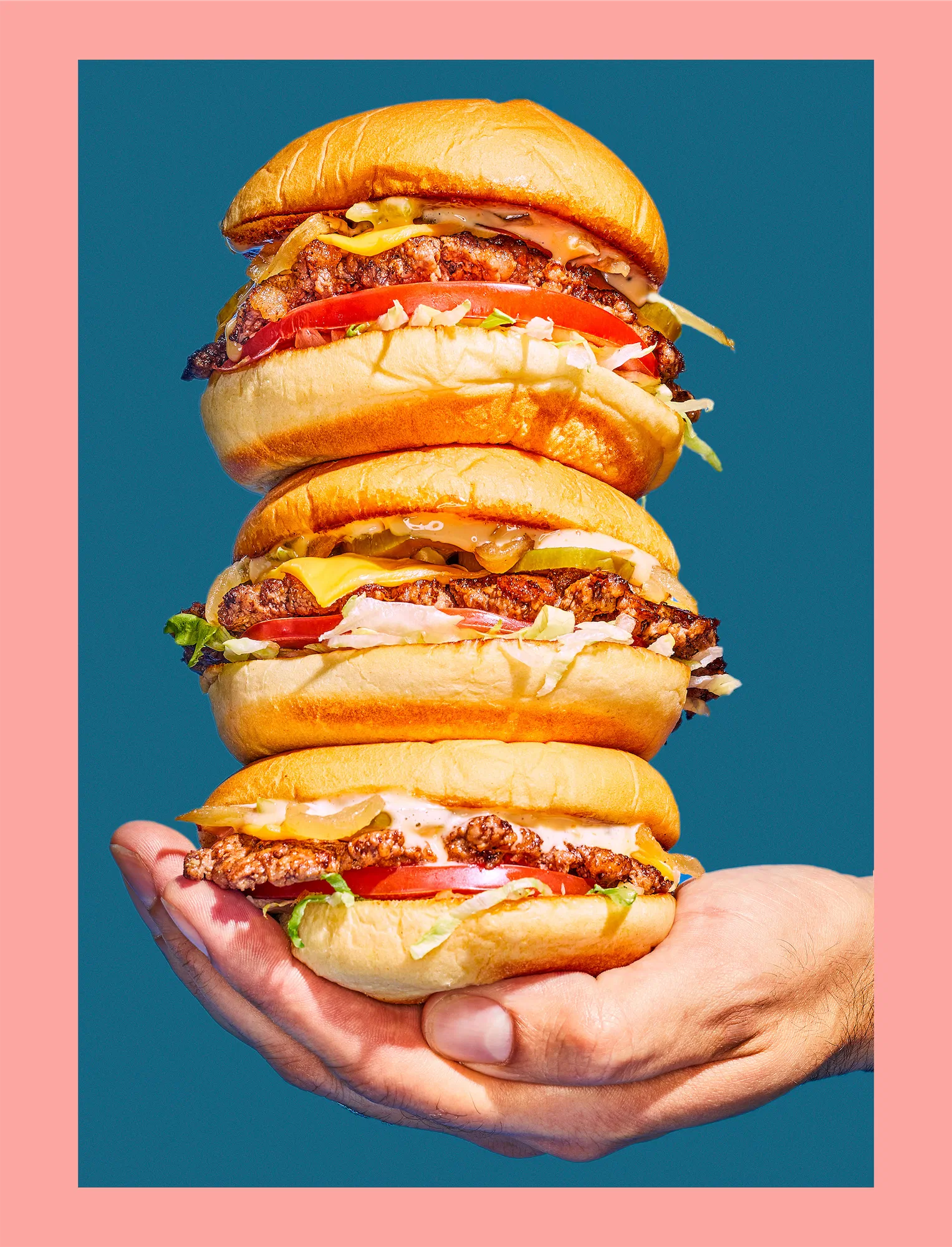 Salt burger chicago stack of burgers in hand on blue background with pink border