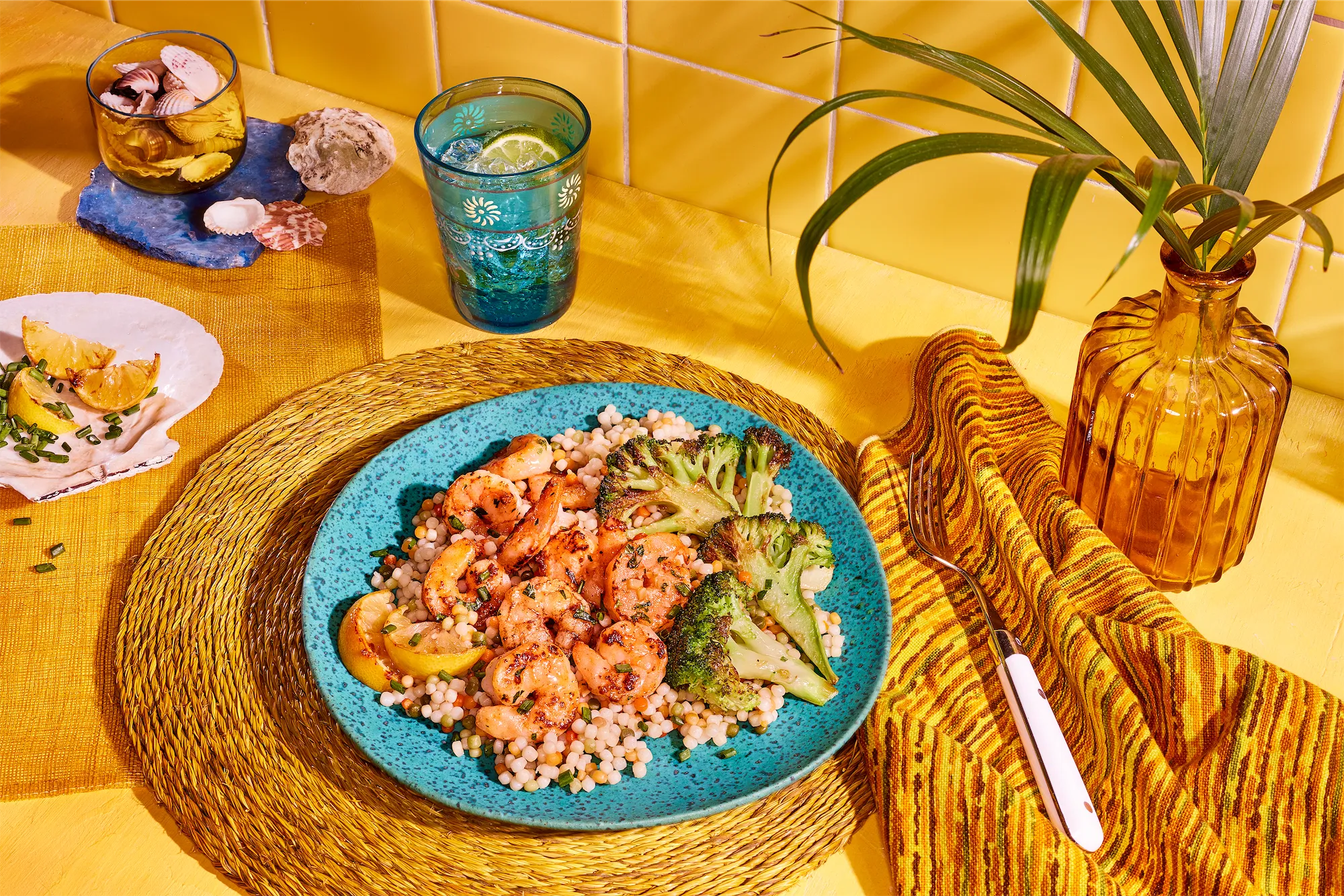 pescanova brand shrimp recipe with rice and broccoli in vibrant yellow scene