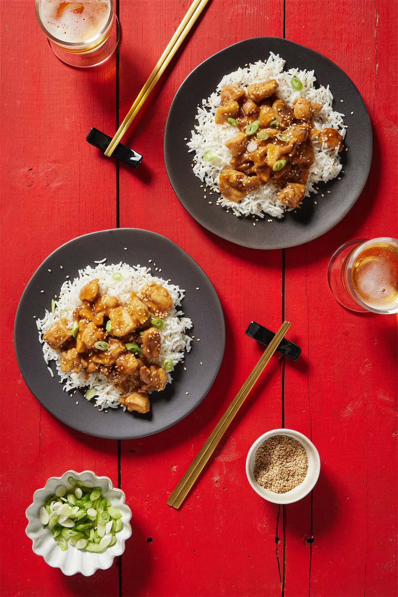receipe developer take-out style chinese chicken and rice with chopsticks on a red background