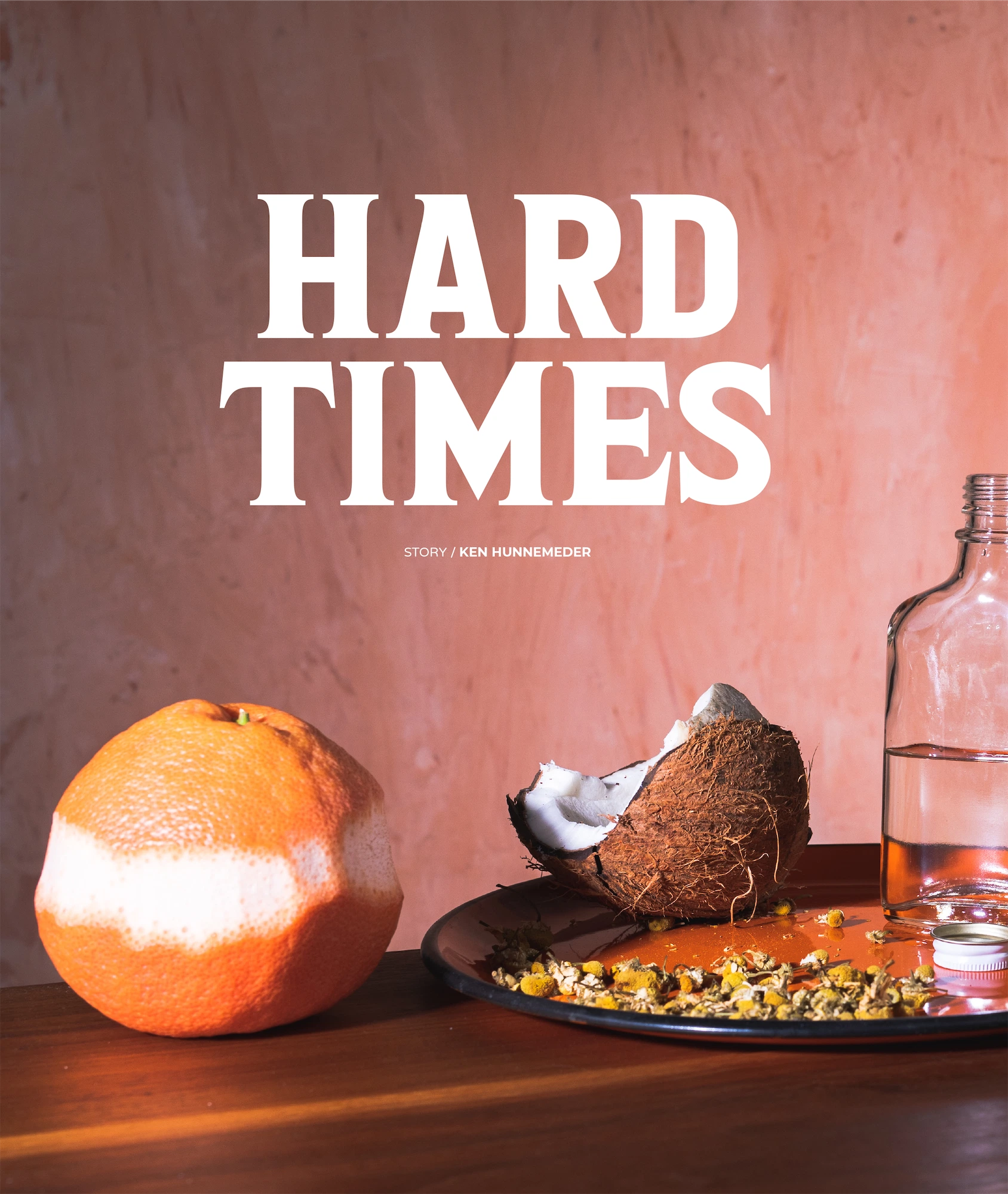 hard times editorial magazine showing a peeled grapefruit and a broken coconut against a peach colored background