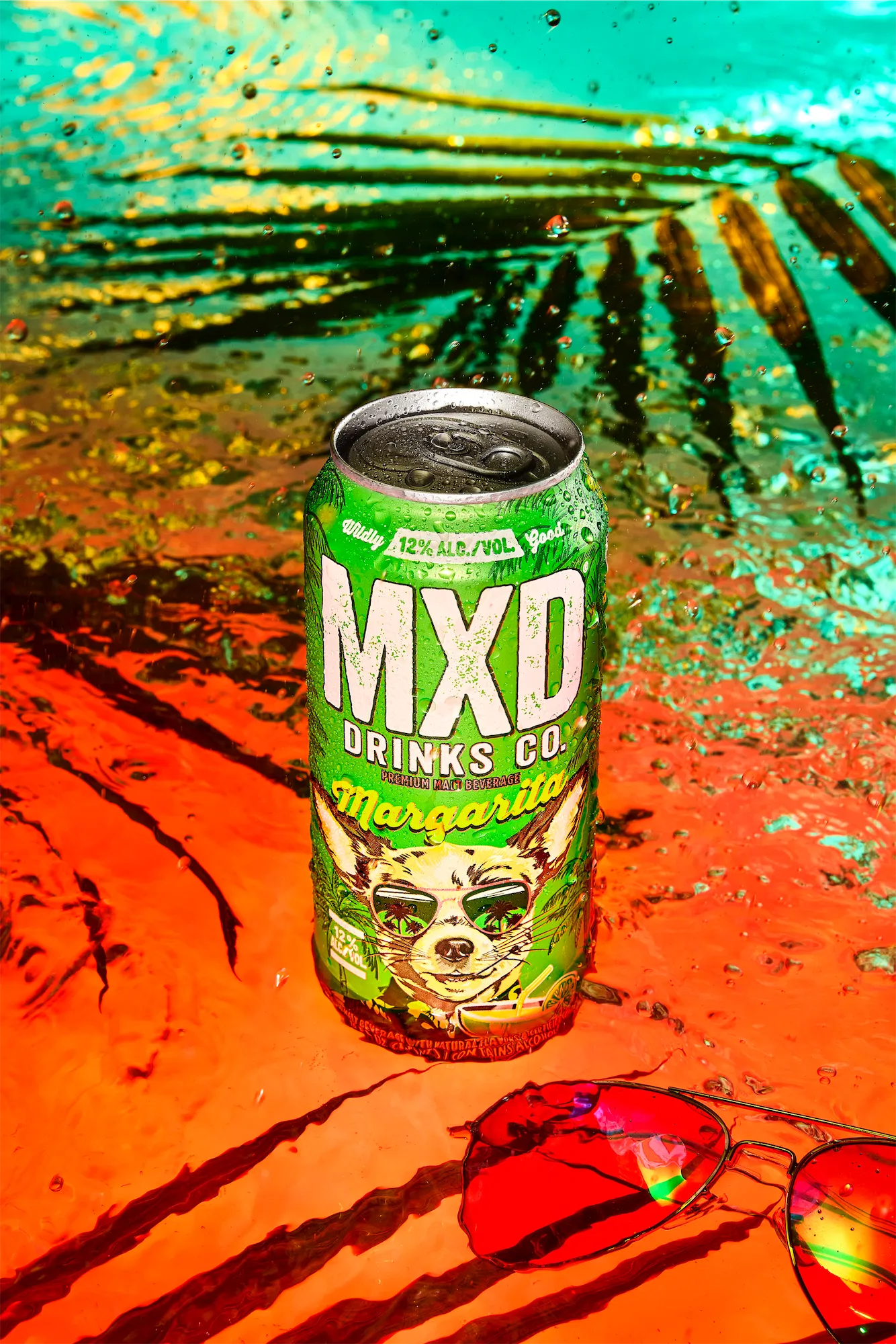 MXD drinks brand photo of margherita canned cocktail in a pool with palm leaves and sunglasses