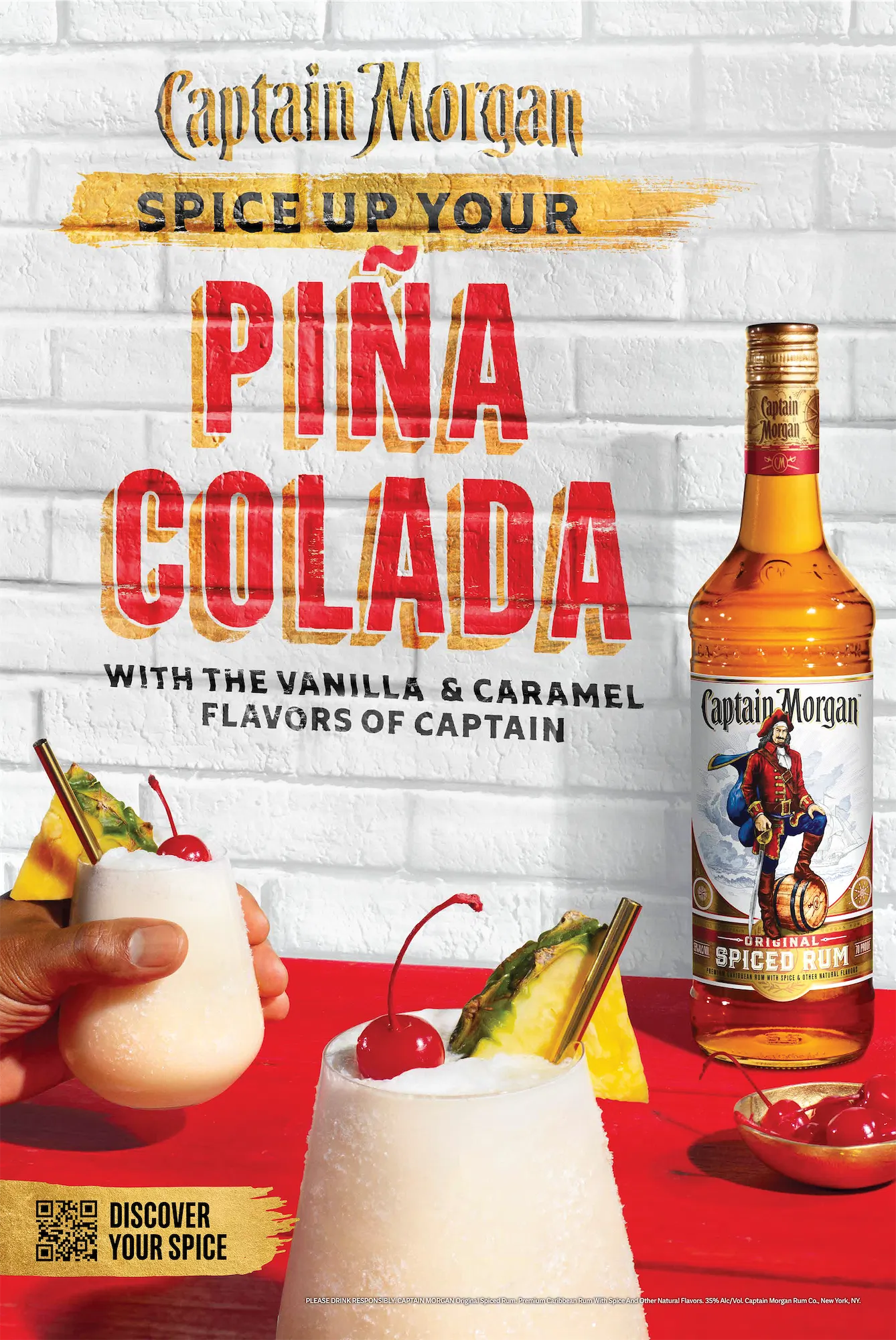 Captain Morgan Original Spiced Rum bottle next to creamy pina colada garnished with pineapple and cherry