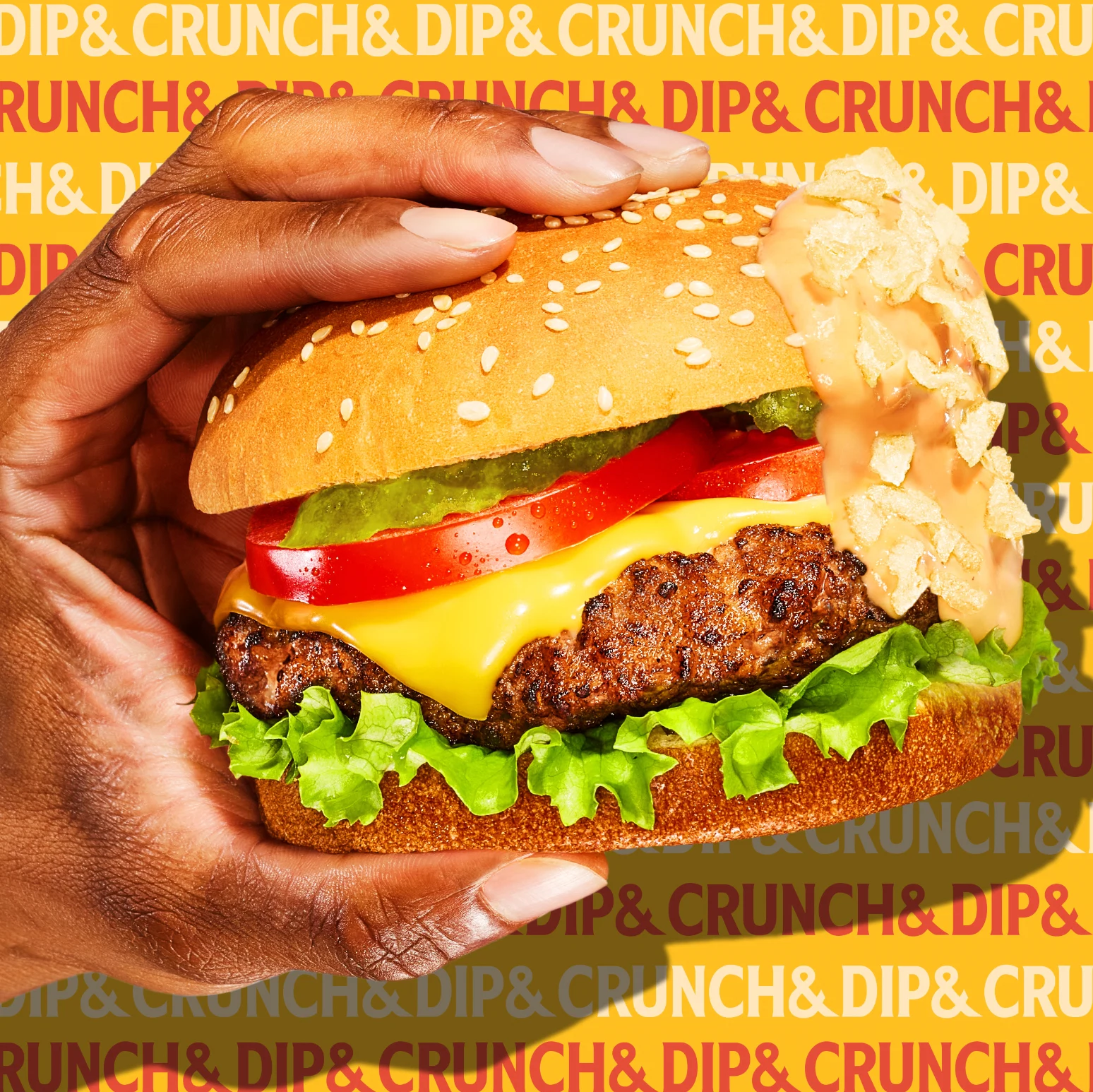 kraft brand dip & crunch product on a classic burger being held by brown skin hand