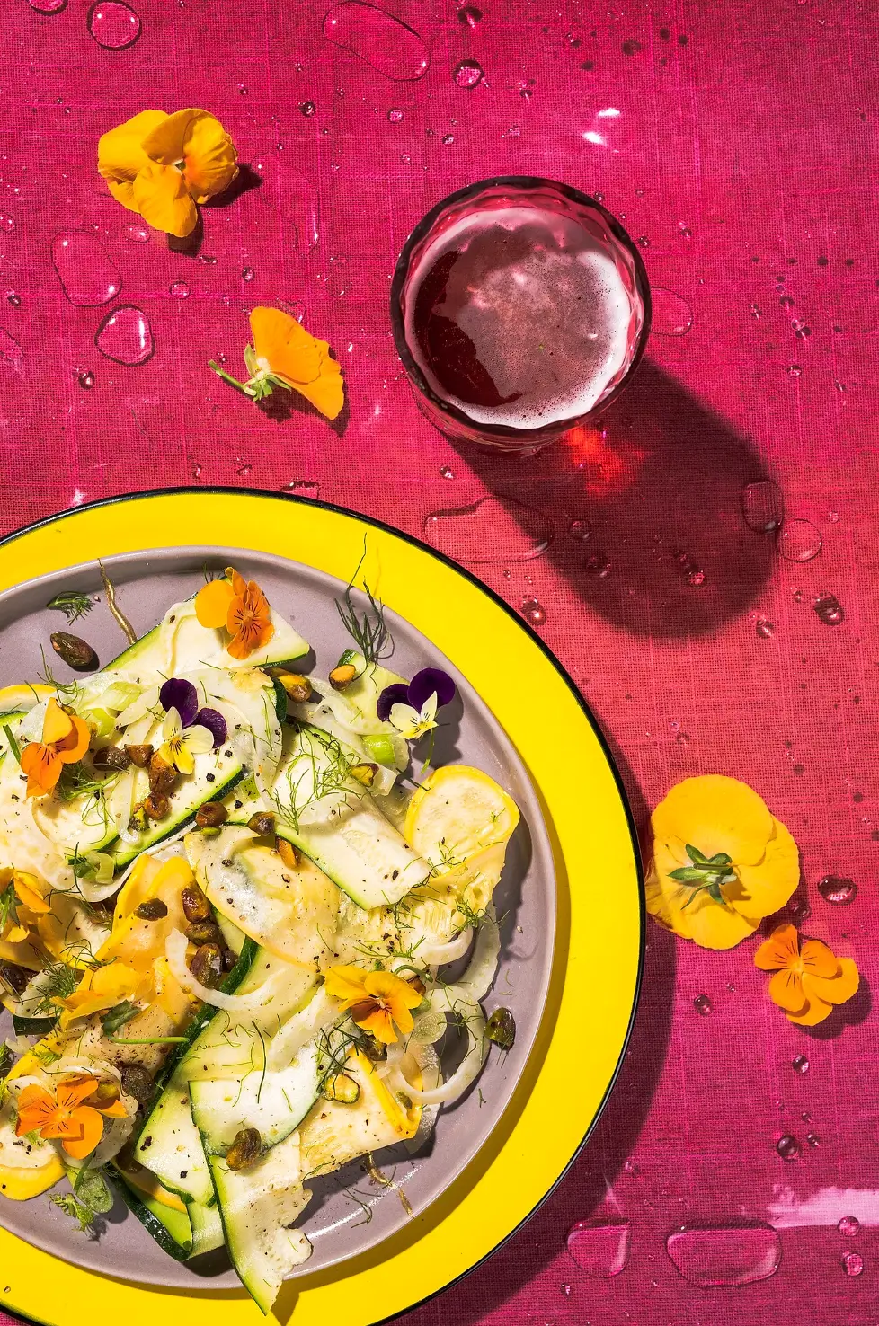 zucchini courgette salad with edible flowers on a vibrant colorful background