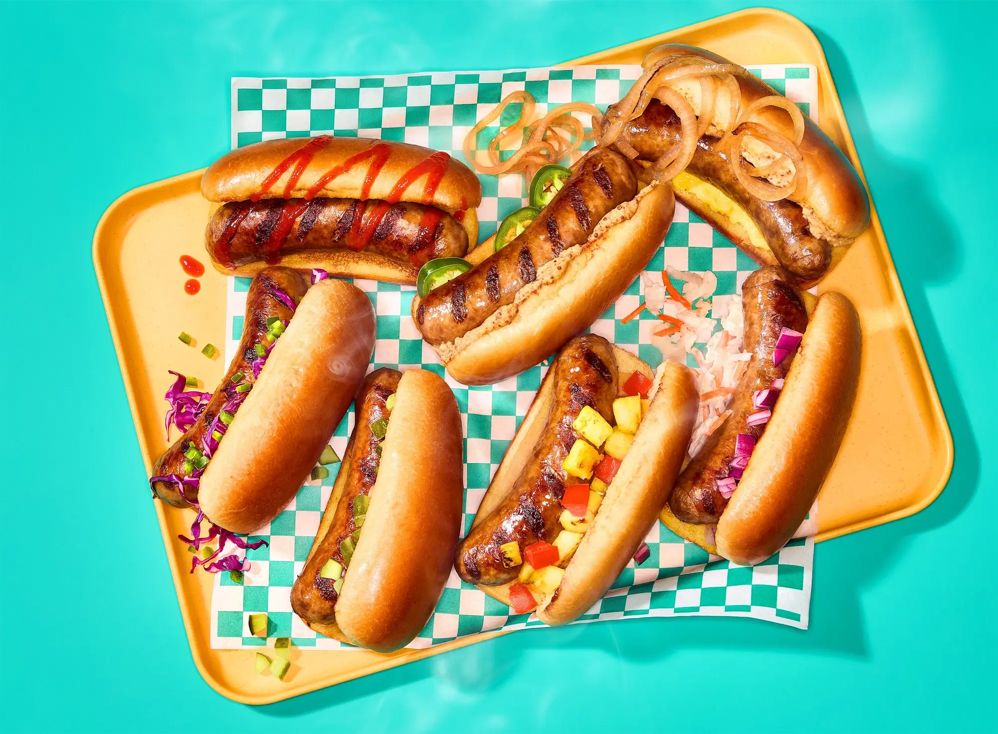Johnsonville sausages hot dogs with toppings on vibrant background