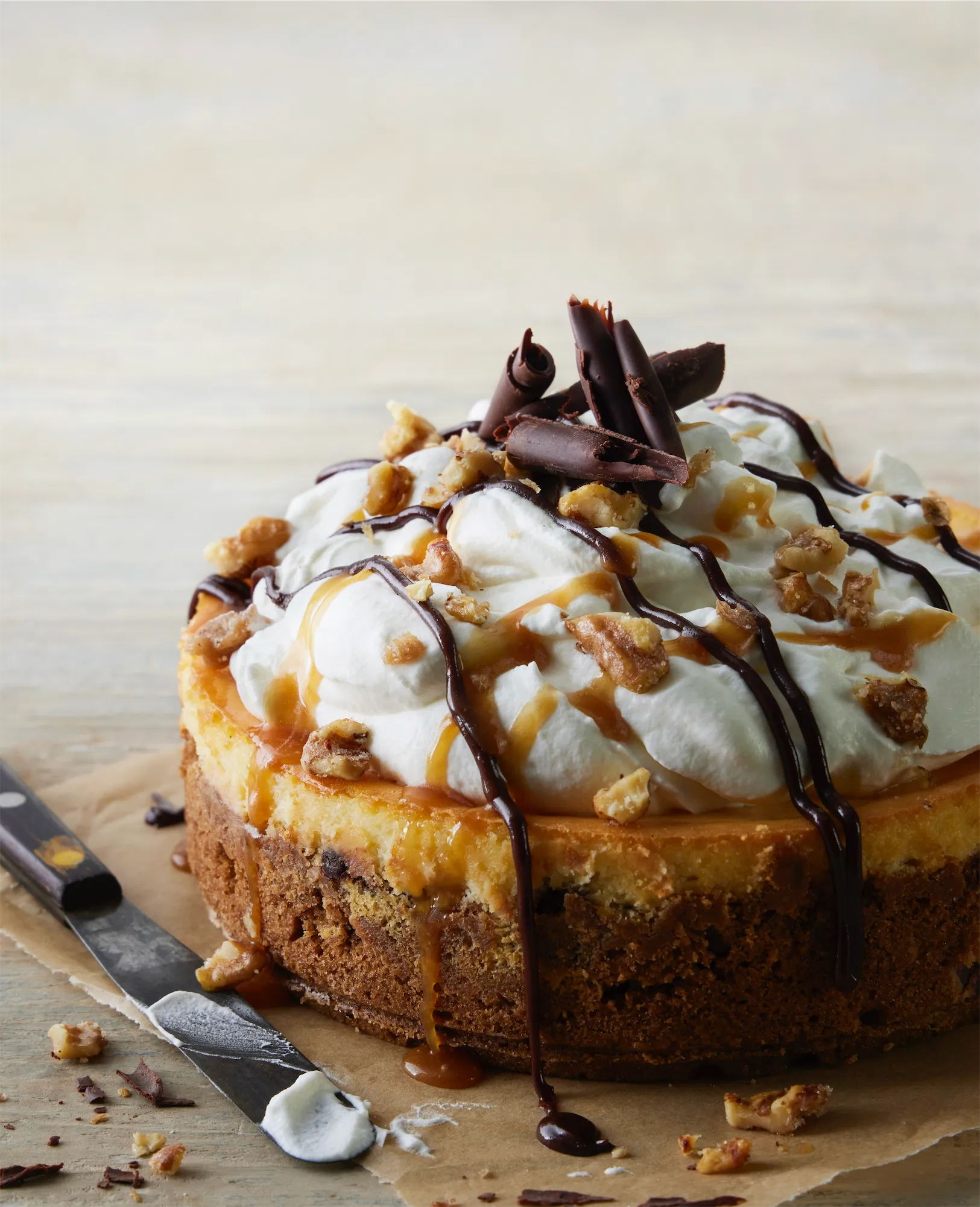 chocolate chip cheesecake with caramel drizzle and chocolate curls