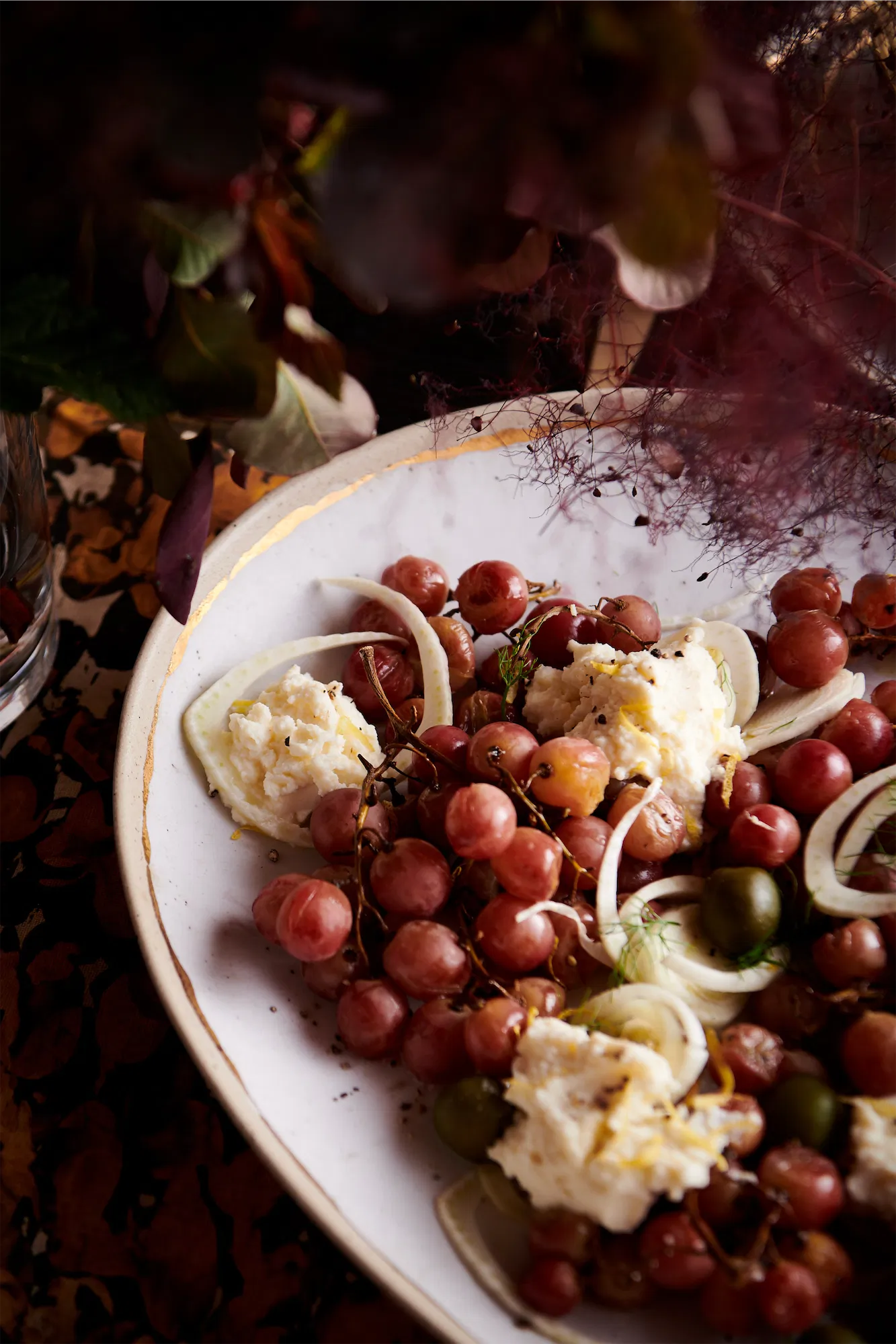 Crate and barrel gold rim platter with roasted grapes and soft cheese fall themed