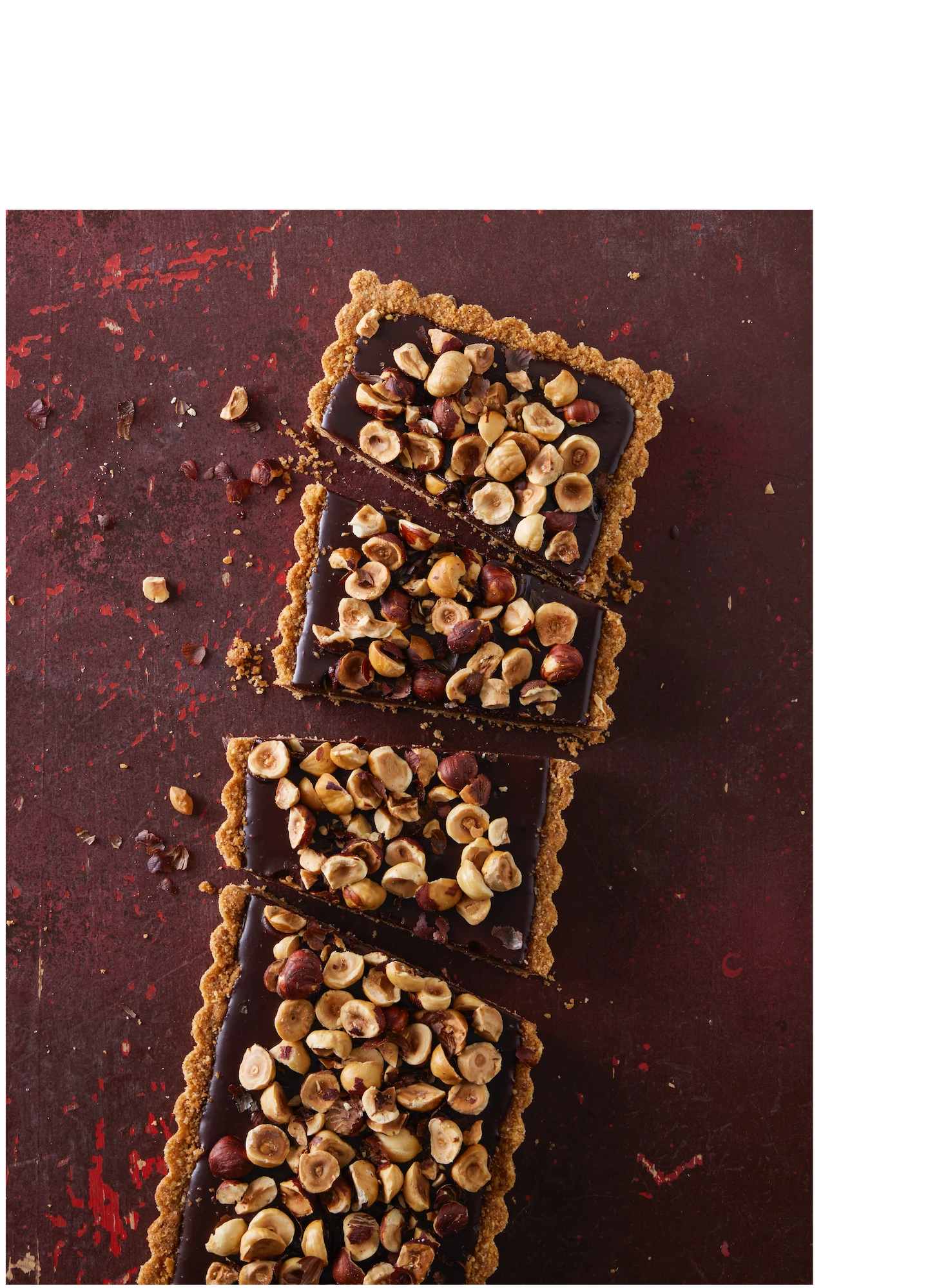 1 rectangular chocolate hazelnut tart on rustic red background