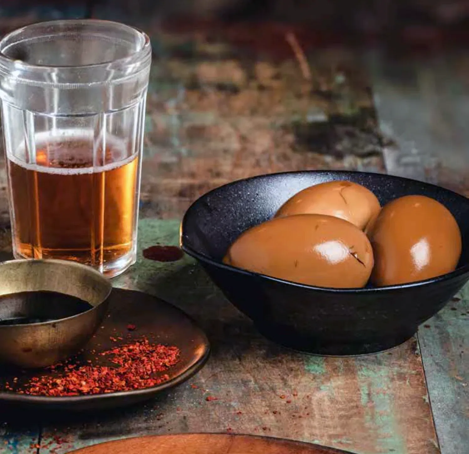 chinese asian boiled eggs with spices and glass of beer
