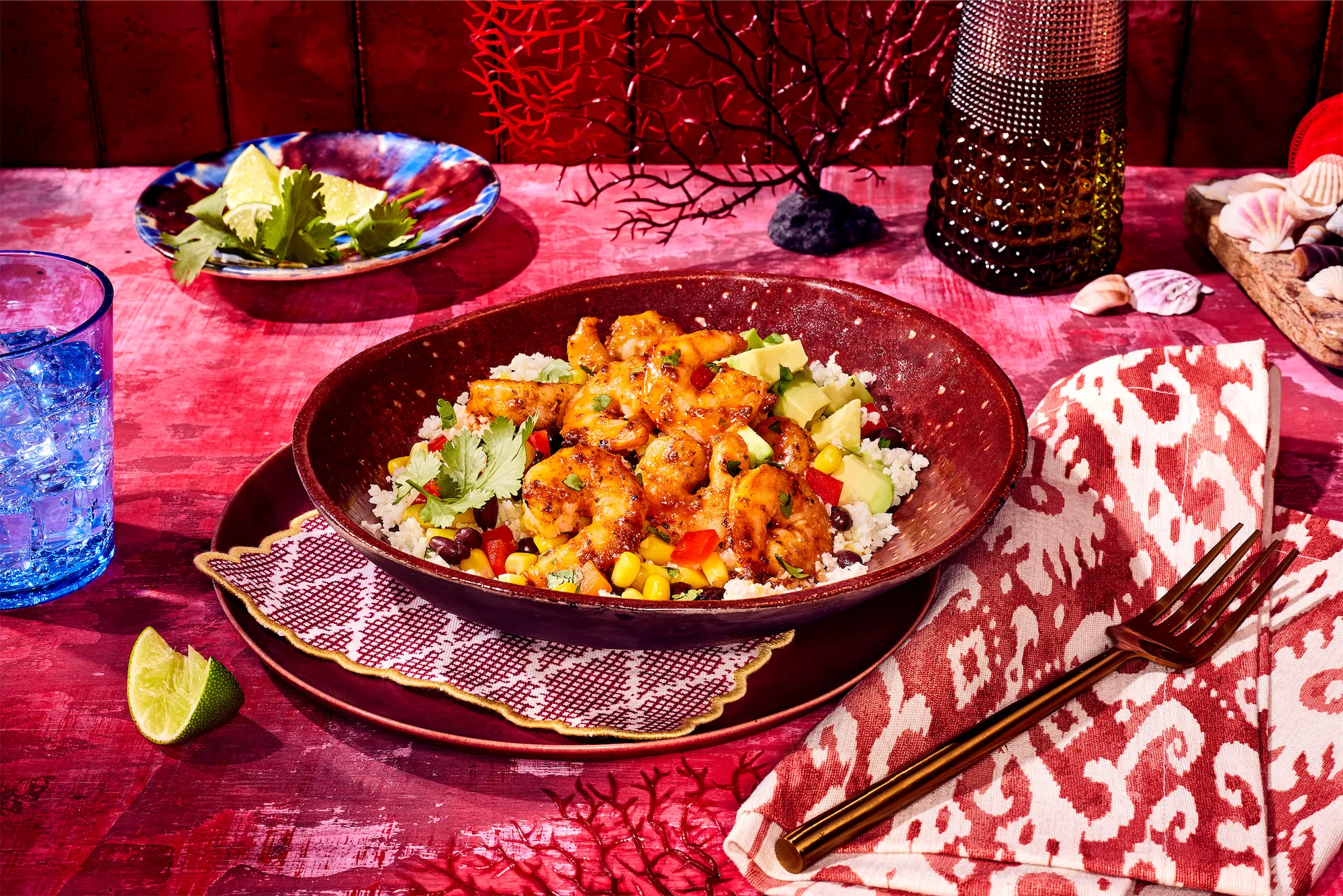 Pescanova brand chipolte shrimp recipe in red dish with red accents and blue glass
