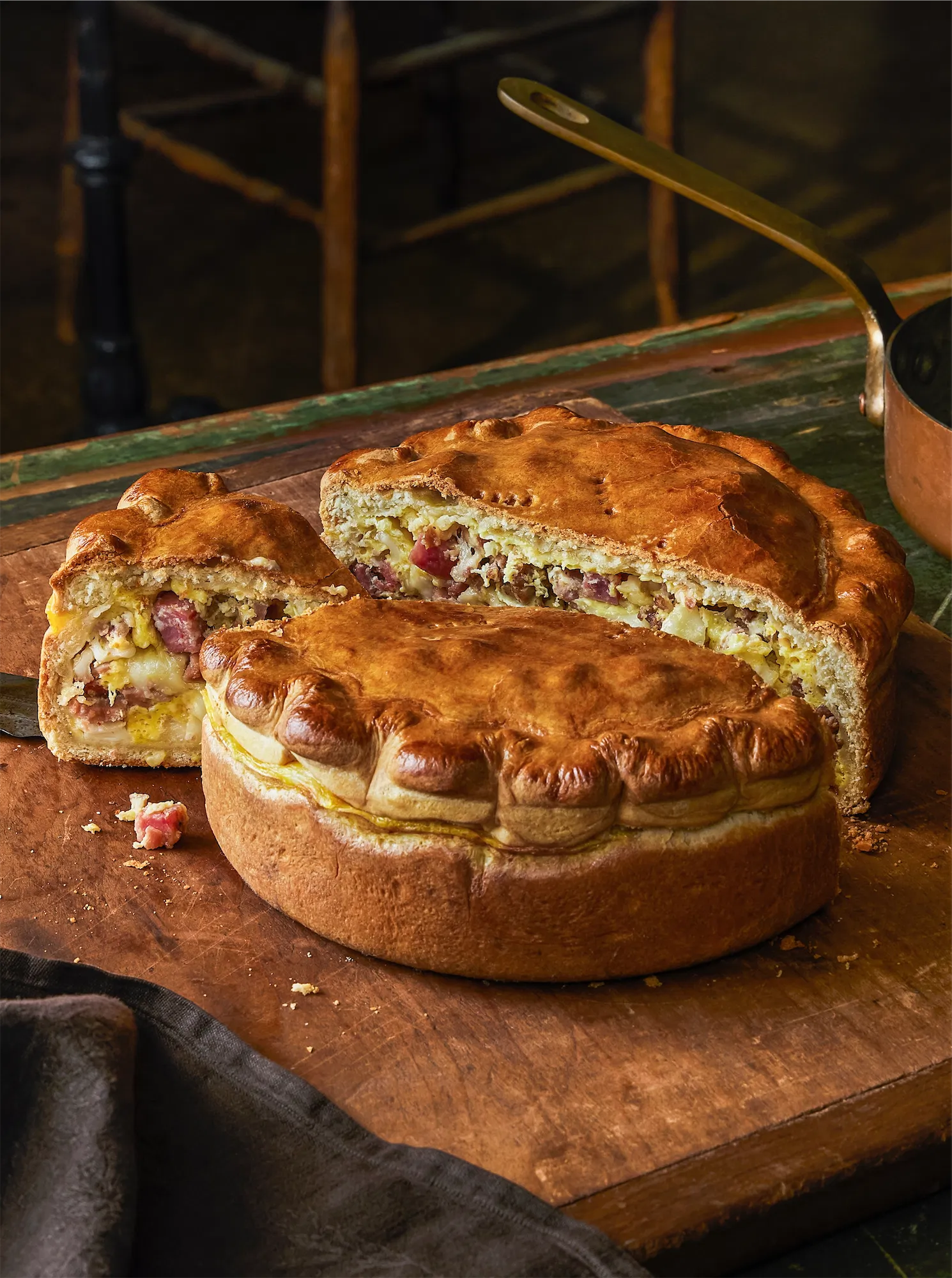 rustic calzone pie cut copper saucepan in background