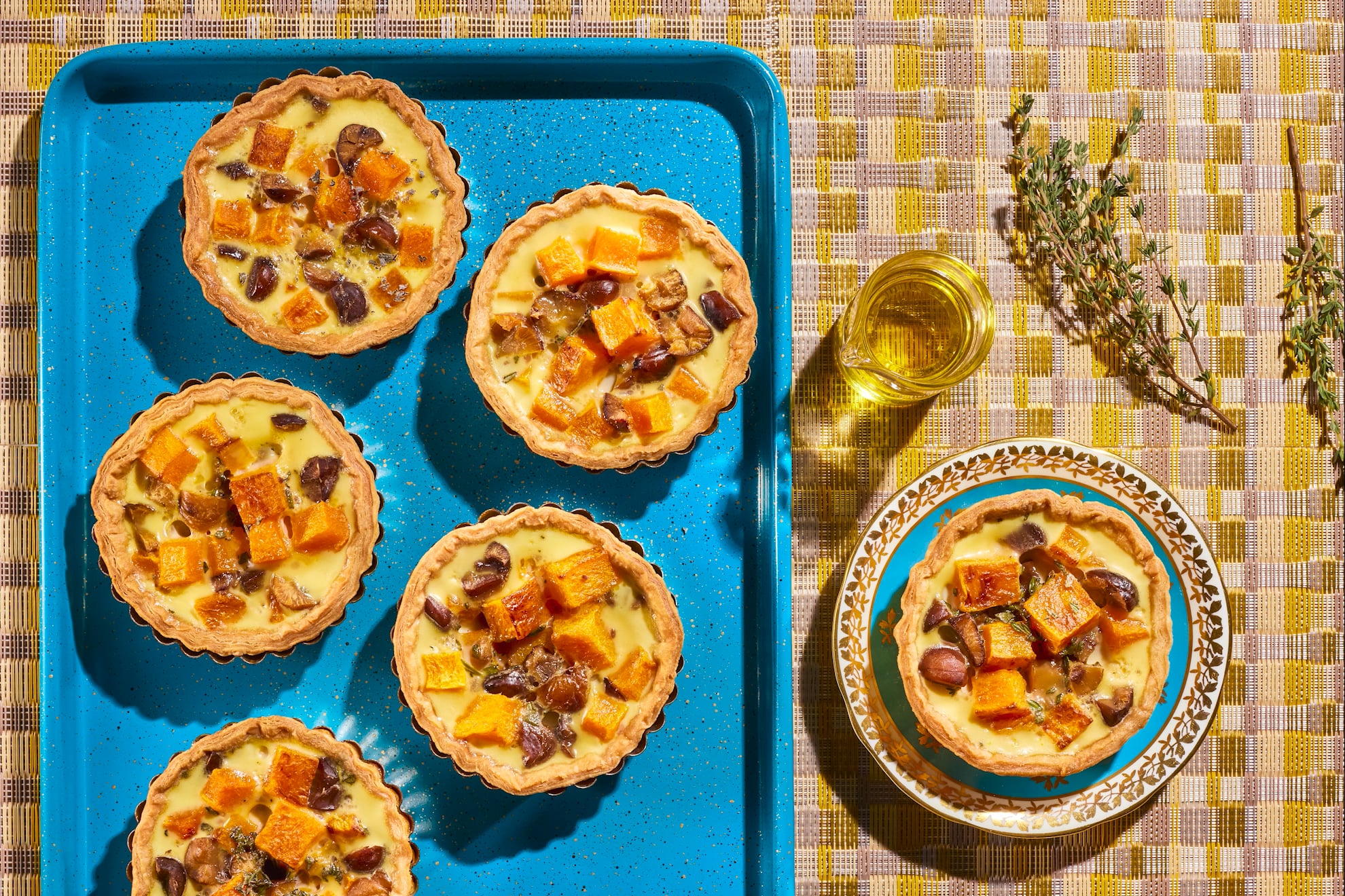 cabot brand mini butternut squash tarts with thyme srigs on a blue tray