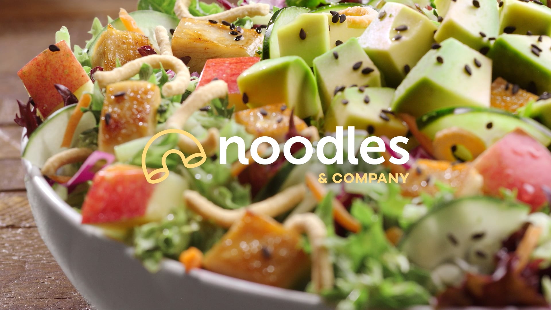 Noodles & company brand advertising with salad and pasta bowls using fresh ingredients flipping and turning around
