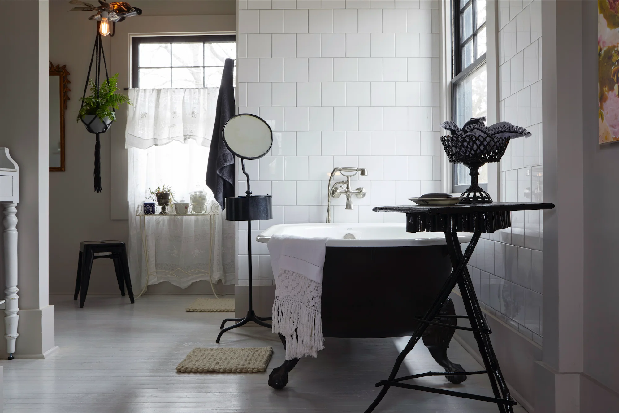 Black and white contemporary vintag ebathroom clawfoot cast iron tub barbers stand mirror wall mount faucet
