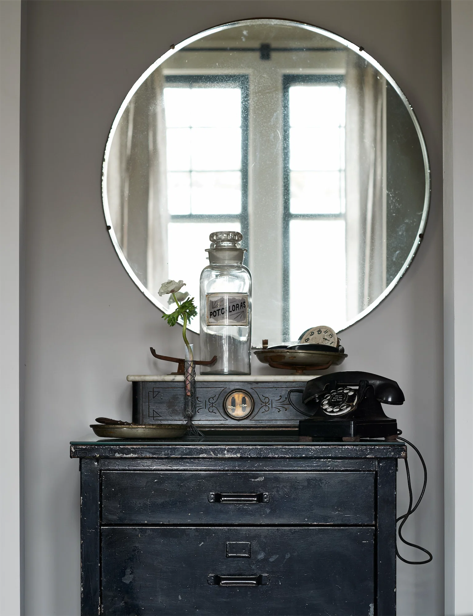 quirky scene interiors round deco mirror bakelite telephone industrial cabinet vintage scale apothecary jar