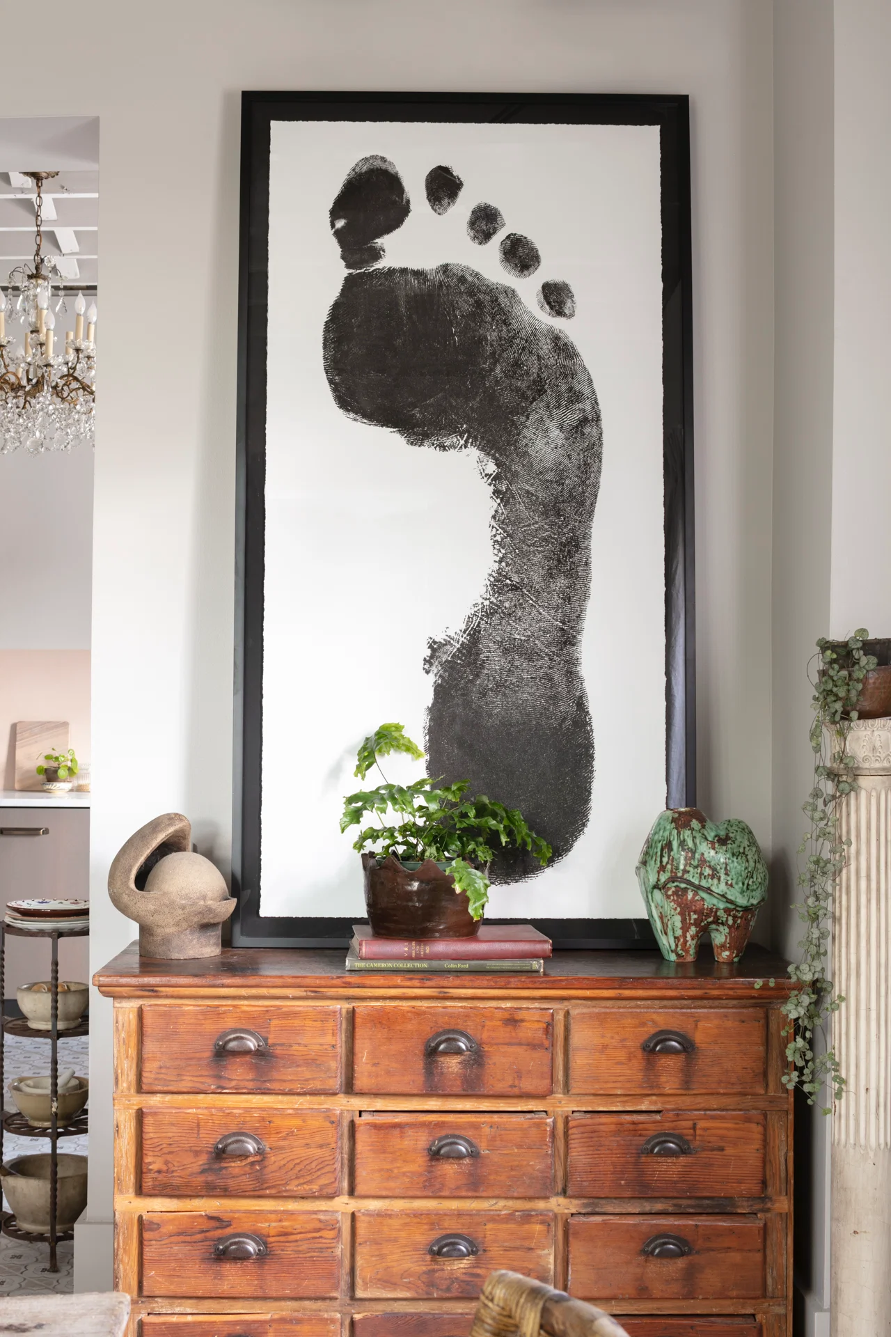 interior artwork oversized blacka nd white footprint antique wood bureau drawers sculptures
