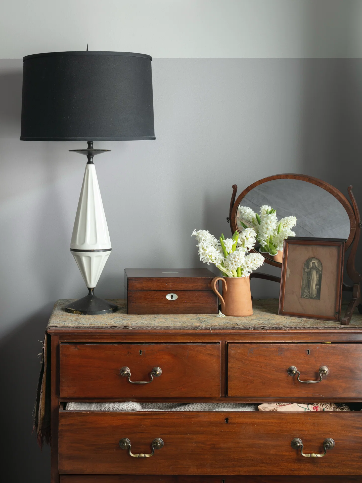 interior scene mcm lamp black shade george 4 chest of drawers antique writing desk vanity mirror holman hunt art pitcher hyacinths