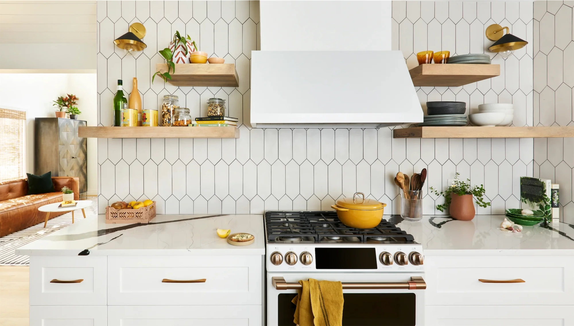 contemporary tasteful white tiled kitchen with gas range artfully arranged open shelving and yellow accents